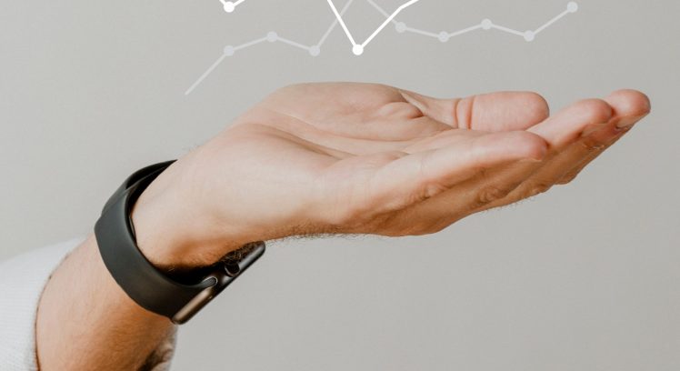 Digital graph performance with businessman hand overlay