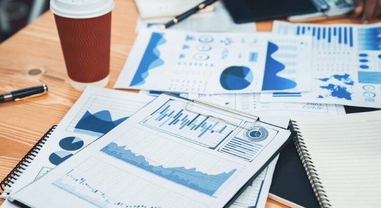 focus-financial-dashboard-paper-showing-graphs-chart-with-blurred-background-diverse-business-people-analyzing-business-data-by-bi-fintech-technology-business-presentation-concord_31965-201142