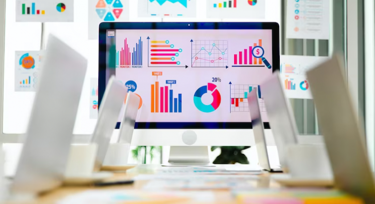 laptop-computer-colorful-post-it-paper-report-data-graph-chart-documents-placed-table-conference-meeting-room-with-analysis-sales-target-screen-monitor-glass-board-blurred-background_102814-4804