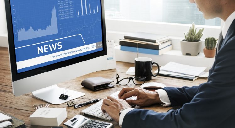 man-looking-stock-market-news-computer