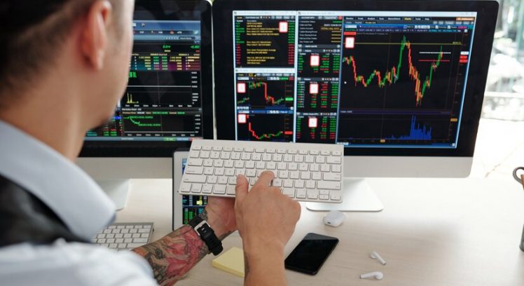 stockbroker-buying-selling-shares-behalf-clients-he-is-looking-computer-screen-pushing-button-keyboard_274689-24513
